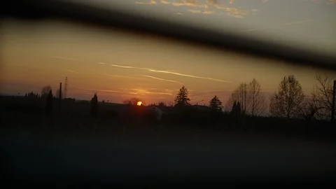 Watching the sunset through slits in the shutter Stock-Footage 127484946