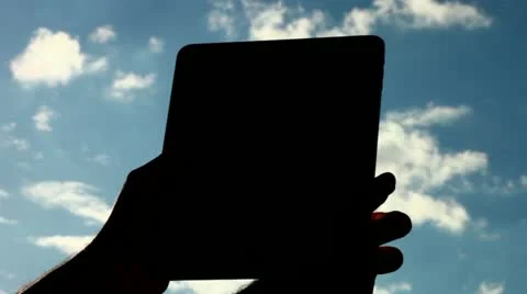Watching tablet against light Stock Footage 10901085