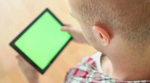 Watching tablet PC with green screen Stock Footage 11809052