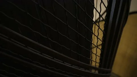 Watching through the metal grid as an old antique elevator shaft arriving Stock Footage 156224411