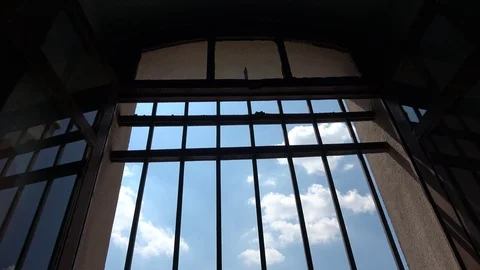 Watching through prison bars on the blue sky Video stock 115539897