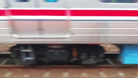 Watching a train stationary on a track from the window of a fast moving train Stock Footage 312862871