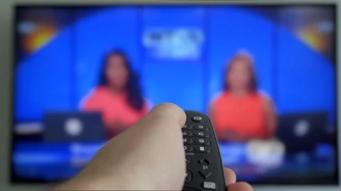 Watching TV-changing channels, blurred TV Hand switches the channels by remote Stock Footage 120823777