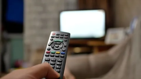 Watching tv close-up hand with remote control switches channels tv  Stock Footage 158165417