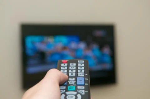 Watching tv with a remote Stock Photos