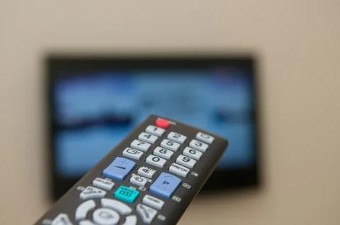 Watching tv with a remote Stock Photos