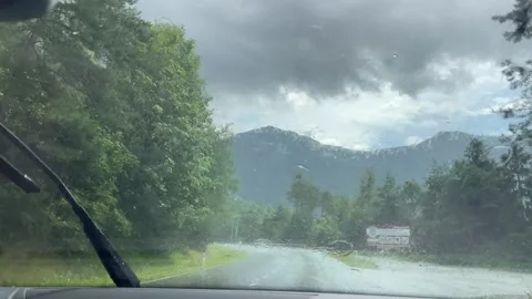 Watching from wind shield, raining weather during travel Stockbeeldmateriaal 284463070