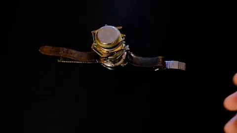 Watchmaker build a tower of old mechanical watches in his workshop. Man inspects Stock-Footage 129999321