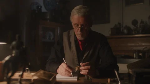 Watchmaker checking an item using the magnifying glass and writing somethin.. Stock-Footage 258302451