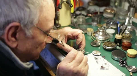 Watchmaker disassembles a wristwatch for repair Stock Footage 21439917