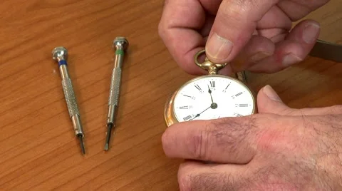 Watchmaker examines pocket watch Stock Footage 7902794