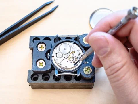 Watchmaker fixes clockwork of mechanical watch Stock Photos