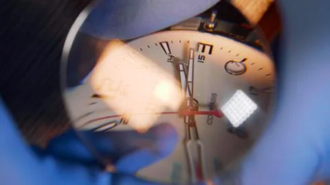 Watchmaker in gloves working reparing vintage watch with help of magnifying Stock Photos