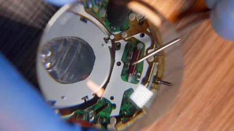 Watchmaker in gloves working reparing vintage watch with help of magnifying Stock Photos