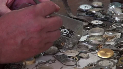 Watchmaker hands choosing small parts for restoration Stock Footage 77234134