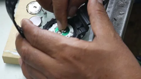 Watchmaker hands using tweezers and tools to repair digital watch movement .. Stock Footage 337408609
