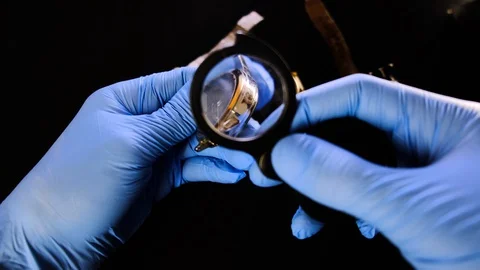 Watchmaker is inspects old mechanical watches in his workshop. Man specialist wi Stock Footage 129999223