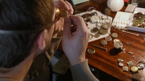 Watchmaker repairing clockwork Stock Footage 72745404