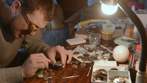 Watchmaker repairing clockwork Stock Footage 79603526