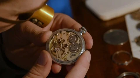 Watchmaker repairing clockwork Stock Footage 79603760
