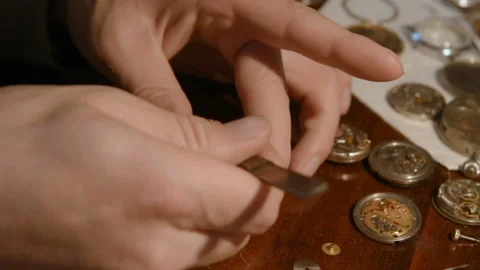 Watchmaker repairing clockwork Stock-Footage 99424194