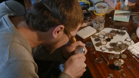 Watchmaker repairing clockwork Stock Footage 100519581