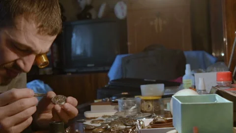 Watchmaker repairing clockwork Stock-Footage 101440100