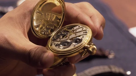 Watchmaker shows off the interior of an old pocket watch Stock Footage 114433534