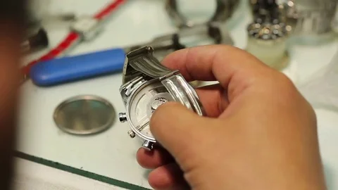 Watchmaker is working on removing the battery of quartz watches and analyzing th Stock-Footage 75450183