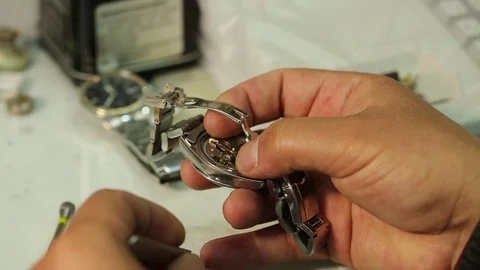 Watchmaker is working on removing the battery of quartz watches and analyzing th Stock Footage 75450449