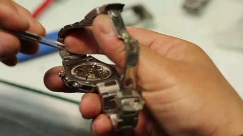 Watchmaker is working on removing the battery of quartz watches and analyzing th Stock-Footage 75451049