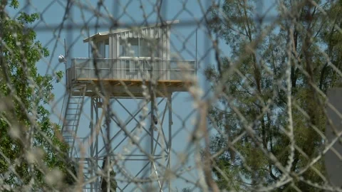 A watchtower behind barbed wires Stock Footage 246999859