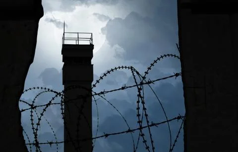Watchtower behind a wall with barbed wire as a symbol of division Stock Illustration