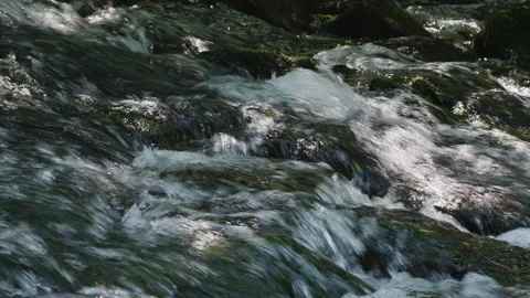 Water 0002. Cascade of Water Over Riverbed Rocks. 4K Locked Tripod Shot. Stock Footage 137106906