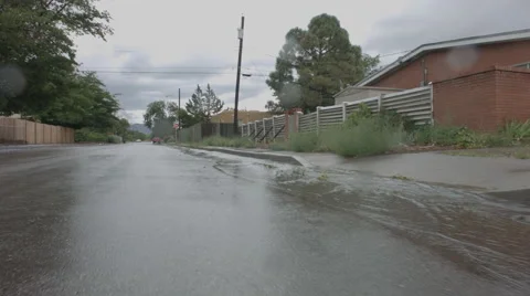 Water After Rainstorm Running Down Street Reverse Stock Footage 53368503