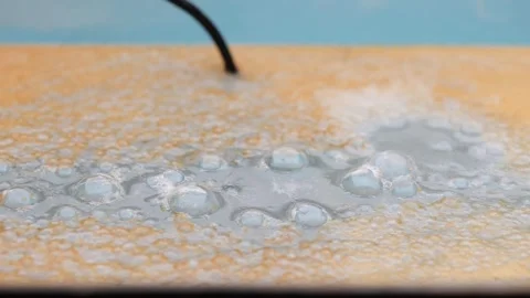 Water and bubbles with rust on the surface from an electrolysis Stock Footage 252241429
