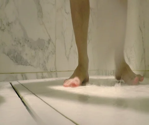 Water and feet in a marble white shower. Stock Footage