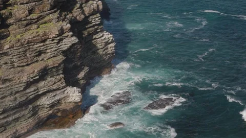 Water and waves surging below the cliffs at Cape of Good Hope Stock Footage 324655491