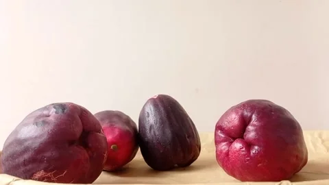 Water apples on a brown table Stock Footage 146248920