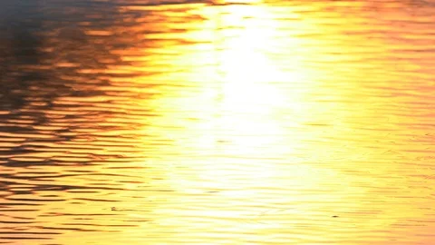 Water backgroun surface motion from sunset in pond background, golden wave Stockbeeldmateriaal 125439804