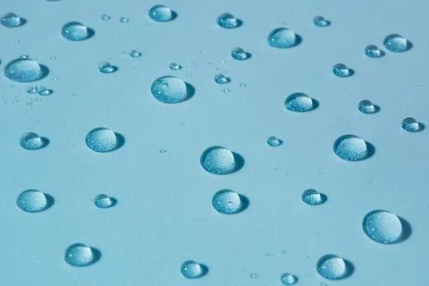 Water background with drops on blue surface, wet pattern Stock Photos