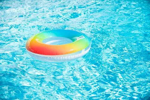 Water background. Pool float, ring floating in a refreshing blue swimming pool Stock Photos