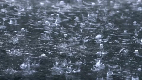 Water Background raindrops make small bubbles in puddles, Stock Footage 130956171