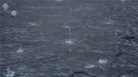 Water Background raindrops make small bubbles in puddles, Stock Footage 140979325