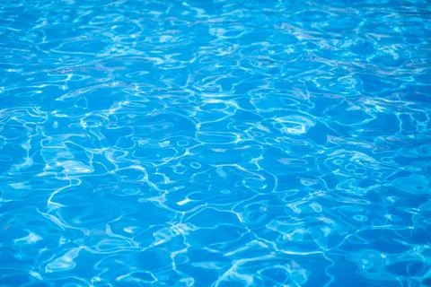 Water background, ripple and flow with waves. Summer blue swiming pool Stock Photos