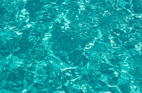 Water background, ripple waves. Blue swiming pool pattern. Sea surface. Water in Stockfoto's