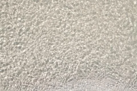 Water background with ripples for abstract pattern. Transparent water on se.. Stock Photos