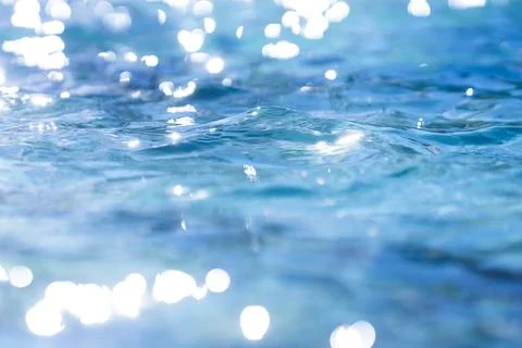 Water background with surface ripple pattern. Water texture with blue waves Stock Photos