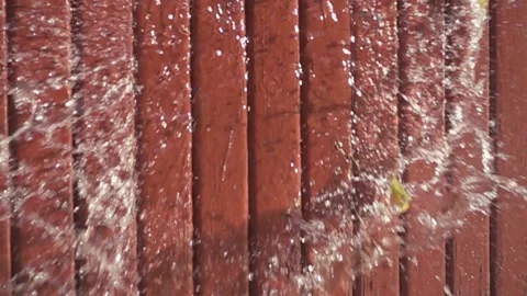 Water balloon exploding on wood Video stock 135930316
