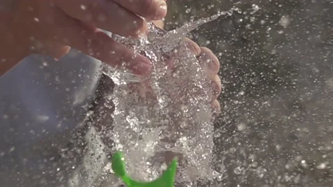 Water balloon exploding on wooden boards. Water explosion in slow motion Stock Footage 146810765